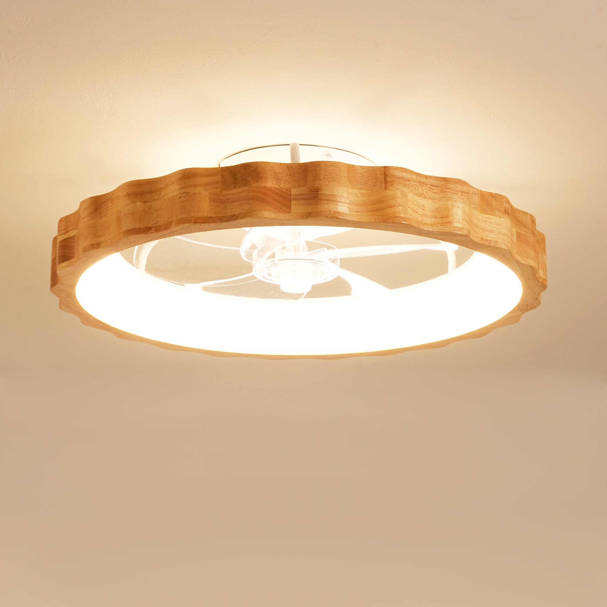 A round ceiling light fixture with a natural wood scalloped outer frame and a bright white diffuser, shown illuminated on a beige ceiling.